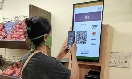 Person scanning QR at store