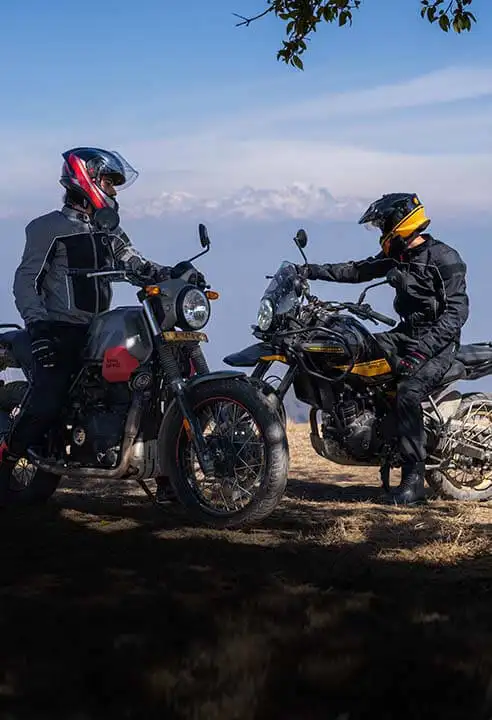 Two riders resting on motorcycles